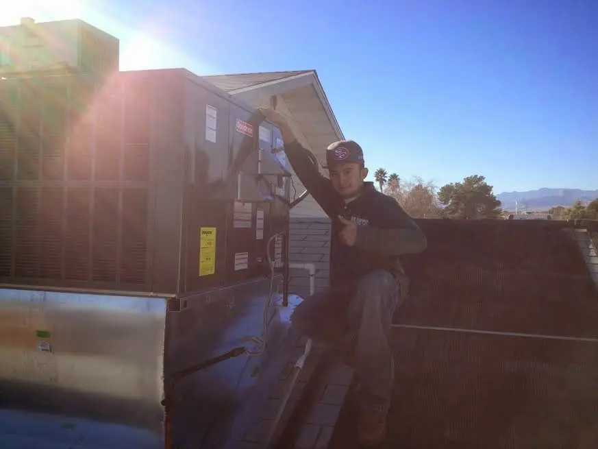 HVAC technician performing Boiler Repair on a rooftop unit in Worthington